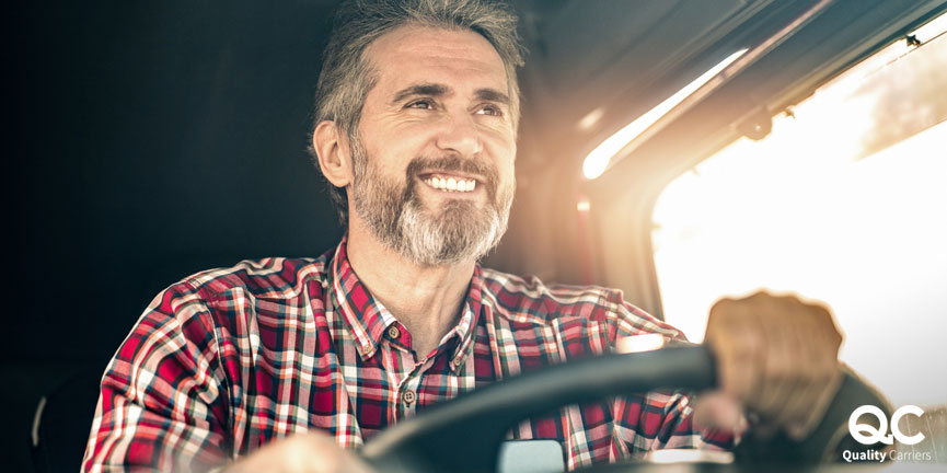 man regional truck driving while smiling