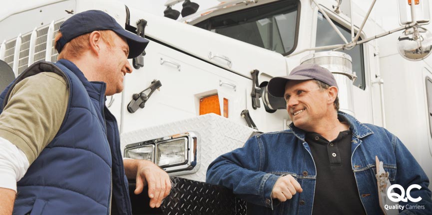 two man talking to each other with white truck