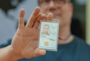 man holding a twic card